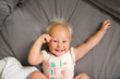 © Christin Lola - Happy One Year Old Baby Girl Laying in Bed