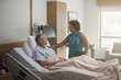 © John Fedele/Blend Images - Doctor talking to patient in hospital room