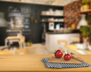 Wall Mural - wooden counter top with tomato and chopping board on kitchen cabinet background