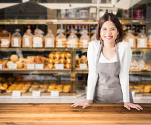 Female Business Owner With Bakery Shop Background