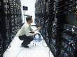 © Erik Isakson/Blend Images - Asian businessman working in server room