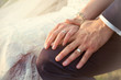 Цlose-up of a bride and groom hands with wedding rings 