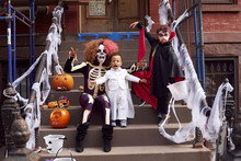Mother And Children Wearing Halloween Costumes
