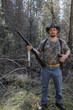 © Eric Raptosh Photography/Blend Images - Caucasian hunter holding gun in forest