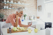 © Lumina Images/Blend Images - Older Caucasian woman using digital tablet in kitchen
