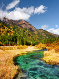 Fototapeta Do pokoju - Beautiful river with azure crystal clear water among fall fields