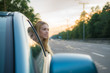 © realstock1 - The girl in the car against the background of a road