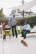 © Hello Lovely/Blend Images - African American father and son talking at barbecue
