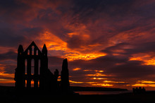 WHITBY, ENGLAND - AUGUST 12: Whitby Abbey Against A Dramatic Fiery Sunset. In Whitby, North Yorkshire, England. On 12th August 2016