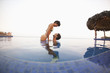 © Sollina Images/Blend Images - Hispanic couple enjoying swimming pool