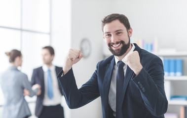 Wall Mural - Cheerful businessman with raised fists