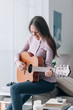 © stokkete - Girl playing guitar at home
