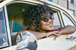 © Peathegee Inc/Blend Images - Mixed race woman sitting in vintage car