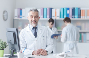 Wall Mural - Confident doctor at the reception desk