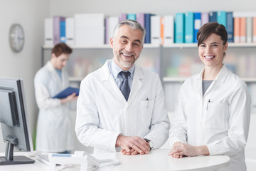 Wall Mural - Doctor at the reception desk with his assistant