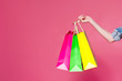 © aemstock - Female hand holding colorful shopping bags