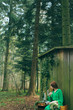 girl near to cabin in forest