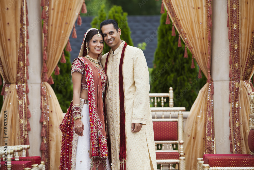 Smiling Indian couple in traditional wedding clothing Stock Photo ...