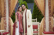 © Jihan Abdalla/Blend Images - Smiling Indian couple in traditional wedding clothing
