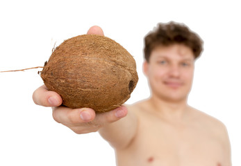 Coconut in a man's hand on a white background