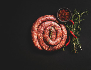 raw beef sausages on a cast-iron pan, selective focus