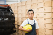 © Sollina Images/Blend Images - Worker standing in manufacturing plant