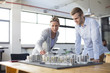 © Resolution Productions/Blend Images - Caucasian architects examining architectural model in office