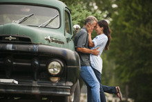 Couple Kissing By Truck Outdoors