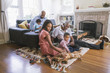 © Hello Lovely/Blend Images - African American family relaxing in living room