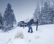 © Chris Clor/Blend Images - Man repairing wooden post in snowy ground