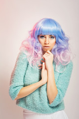 Wall Mural - Beautiful young woman with pastel hair in turquoise fluffy soft sweater