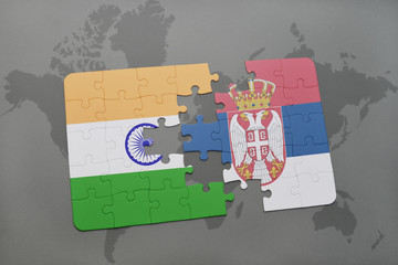 Wall Mural - puzzle with the national flag of india and serbia on a world map background.