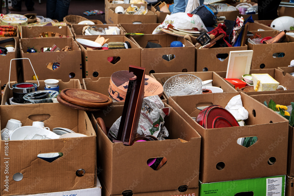 many cardboard boxes with used stuff for sale at the flea market - obrazy, fototapety, plakaty 
