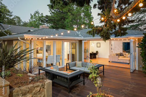 Fotografie, Obraz Home with furniture patio / wooden deck at twilight.