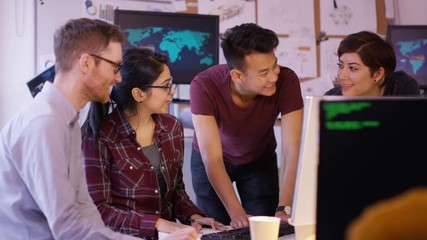 Wall Mural -  Young computer experts working in office with lots of computers