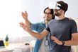 © zinkevych - Positive colleagues testing virtual reality glasses