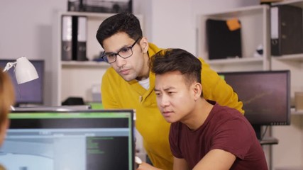 Wall Mural -  Young computer experts working in office with lots of computers