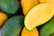 a pile yellow ripe mango and fresh green mango and half mango  on white background healthy fruit food isolated
