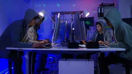 Wall Mural -  Team of young computer hackers trying to gain access to a computer system
