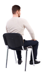 back view of business man sitting on chair. businessman watching. rear view people collection. backs