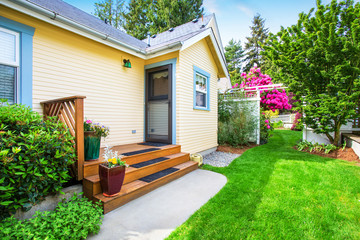  Yellow house backyard area with small porch and stairs