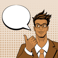 Pop art man. Young hansome man in glasses looking and pointing at speech bubble. Vector illustration in retro comic style. Vector pop art background.