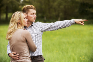 Wall Mural - couple standing outdoors and looking at something