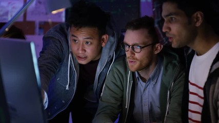 Wall Mural -  Team of young computer hackers trying to gain access to a computer system