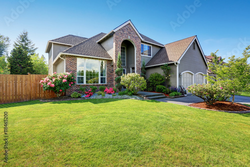 Cuadros en Lienzo Luxury house exterior with brick and siding trim and double garage