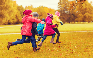 Poster - group of happy little kids running outdoors