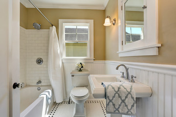 American bathroom interior in white tones and tile floor.