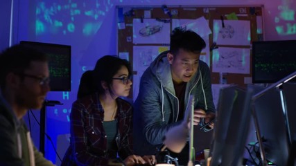 Wall Mural -  Team of young computer hackers trying to gain access to a computer system