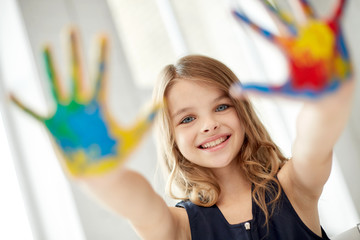 Wall Mural - happy girl showing painted hand palms at home