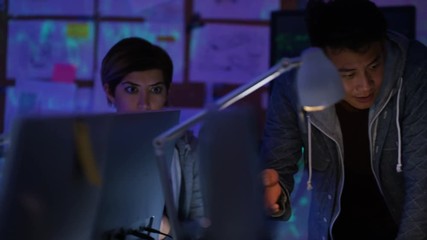 Wall Mural -  Team of young computer hackers trying to gain access to a computer system